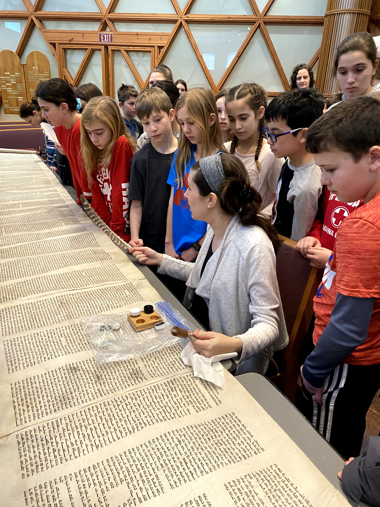 Alex teaches religious school students about caring for torah scrolls in Minnetonka, MN