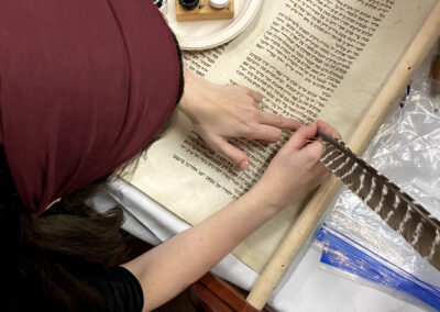 Alex repairs a Holocaust scroll with congregants in Minnetonka, MN